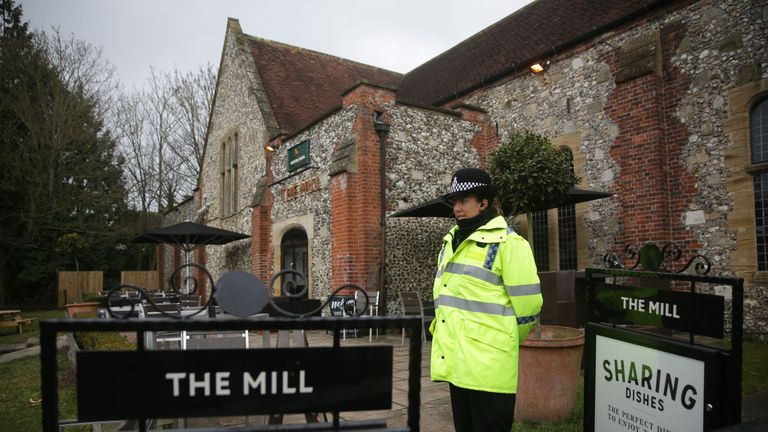 A police officer stands in front of a cordon in front of The Mill pub in Salisbury