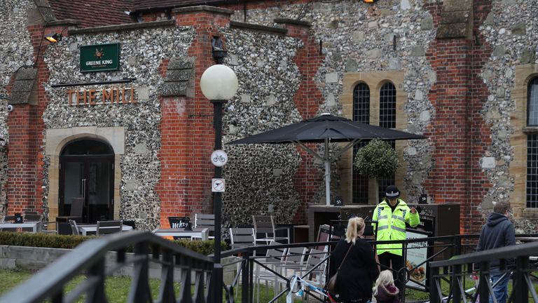 A police officer stands in front of The Mill pub in Salisbury