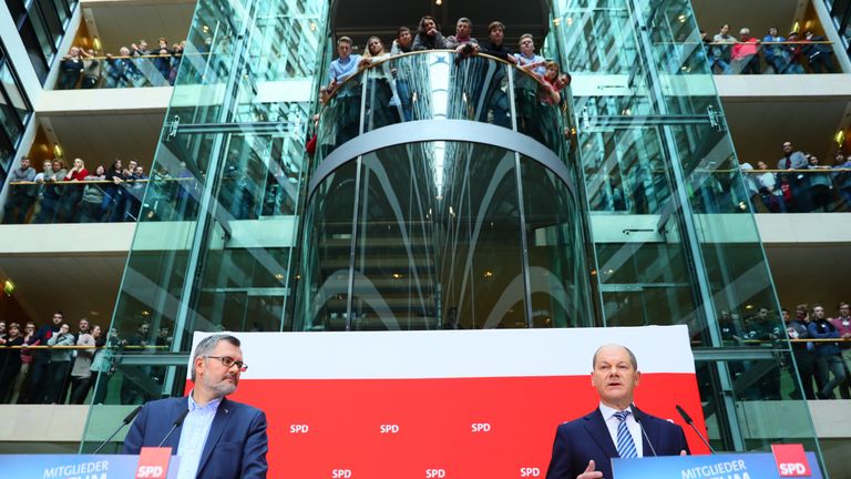 Olaf Scholz (R), interim leader of Germany&#39;s Social Democrats (SPD) party, speaks after the SPD&#39;s treasurer Dietmar Nietan announced the result