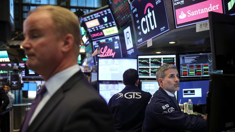 Traders and financial professionals work on the floor of the New York Stock Exchange (NYSE) ahead of the closing bell, March 22, 2018 in New York City. The Dow Jones industrial average closed down more than 700 points on Thursday afternoon. Markets reacted to the Trump administrationâs announcement of approximately $50 billion worth of yearly tariffs on Chinese imports