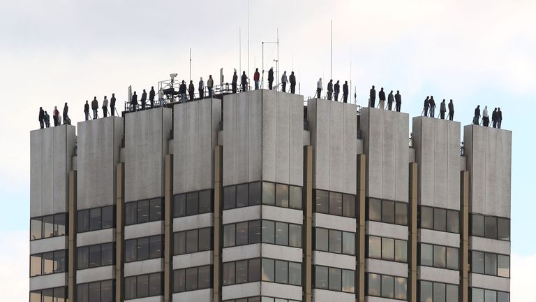 The sculptures of 84 men, made by American artist Mark Jenkins and his collaborator, Sandra Fernandez, part of Project 84, a campaign to raise awareness of the fact that 84 men take their own lives every week in the UK, ontop of London Television Centre after the installation was unveiled. PRESS ASSOCIATION Photo. Picture date: Monday March 26, 2018