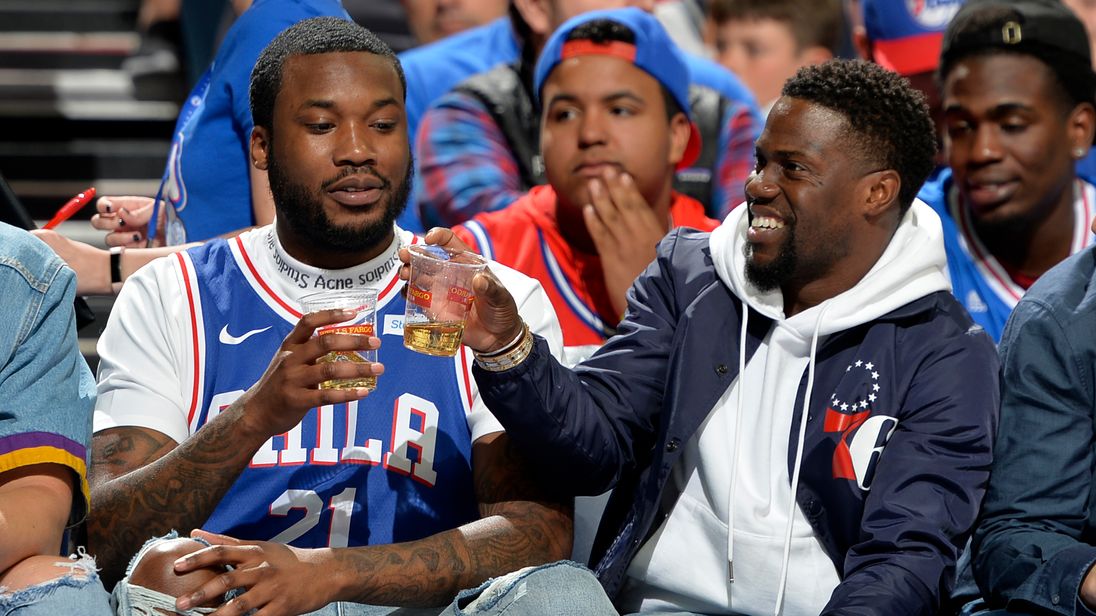 Mill and Hart celebrate with a drink courtside at the game