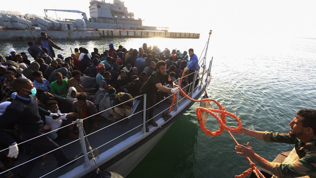 Illegal migrants of different African nationalities arrive at a naval base in the capital Tripoli