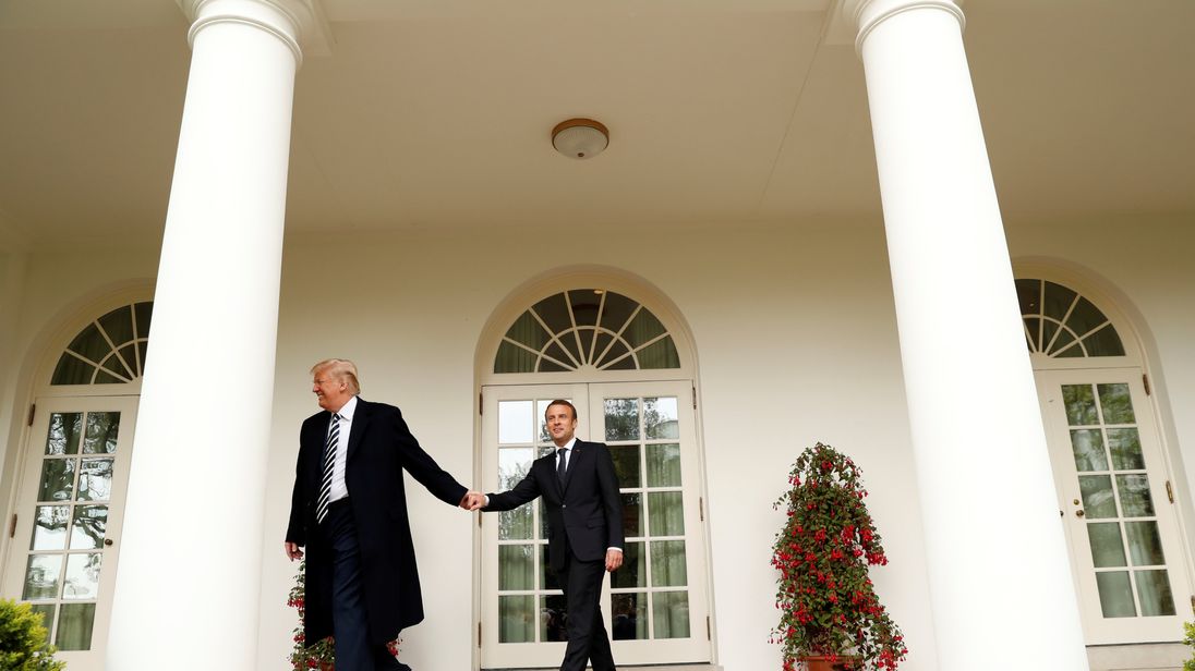 U.S. President Donald Trump (L) and French President Emmanuel Macron walk down the colonnade at the White House following the official arrival ceremony for Macron on the South Lawn of the White House in Washington, U.S., April 24, 2018. REUTERS/Kevin Lamarque 
