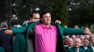 Patrick Reed receives the green jacket after winning the Masters in Augusta