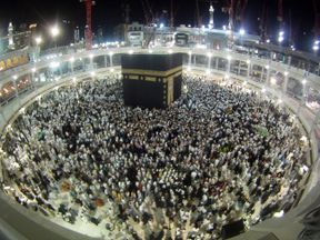 Muslims circle the Kaaba and pray during Umrah, as construction cranes are seen at the Grand Mosque, in the holy city of Mecca January 10, 2014