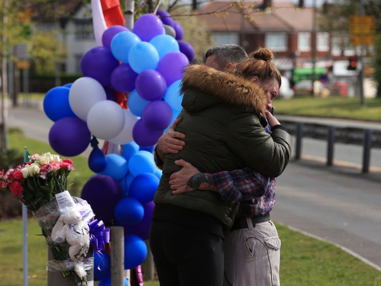 Two people hug as they visit Alder Hey Hospital in Liverpool after Alfie Evans' death