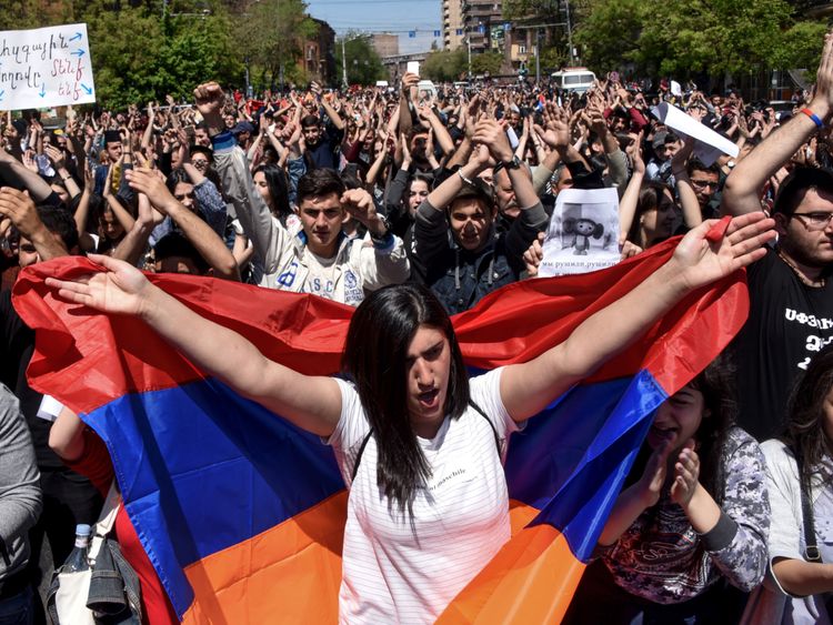 Demonstrators march through the streets of Yerevan