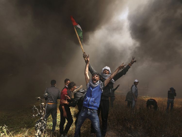 Palestinian demonstrators shout during clashes with Israeli troops