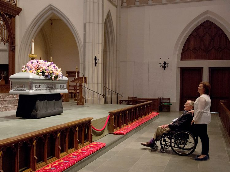Former President George H. W. Bush looks at the casket with his daughter Dorothy 