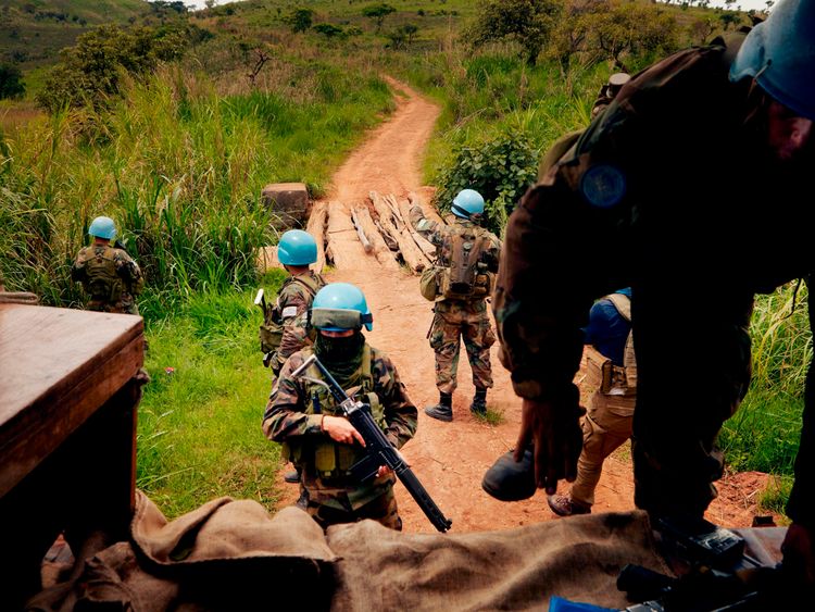 UN peacekeeping soldiers return to their patrol vehicle in the Djugu area of Iuri