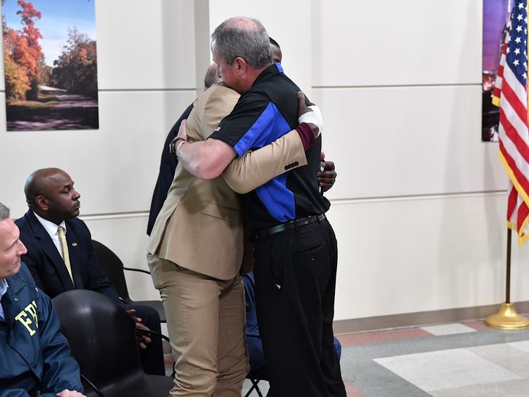 James Shaw (l) is embraced by the Waffle House President Walt Ehmer 