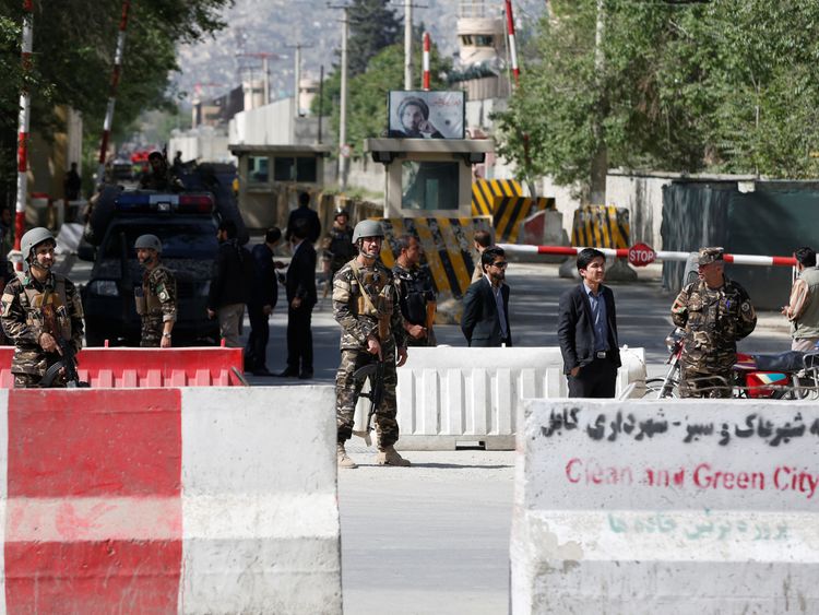 Security forces stand guard at the site of the blast