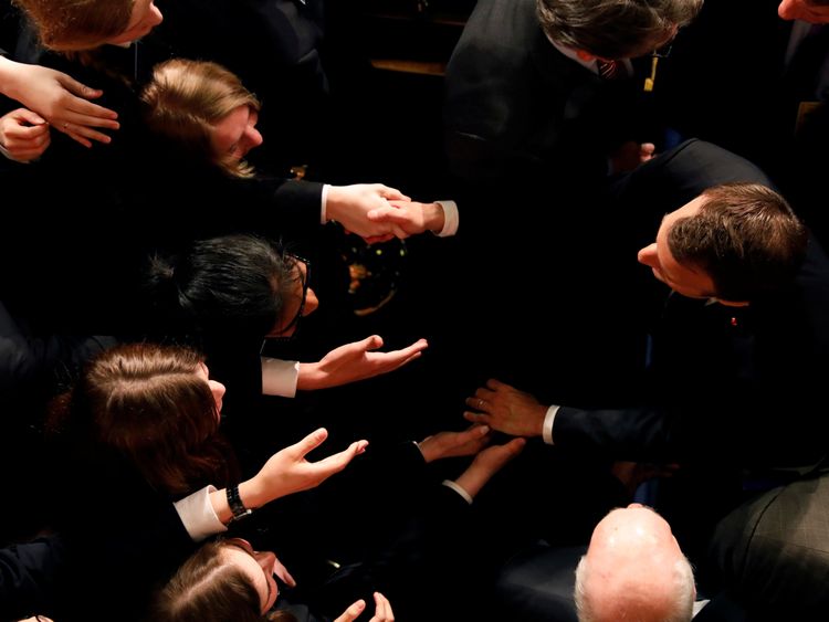 The French president greets students after his address to Congress