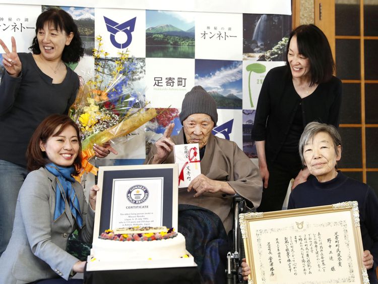 Masazo  with his family as he receives the Guinness World Records certificate