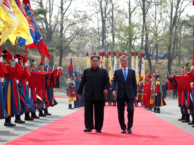 South Korean President Moon Jae-in walks with North Korean leader Kim Jong Un at the truce village of Panmunjom