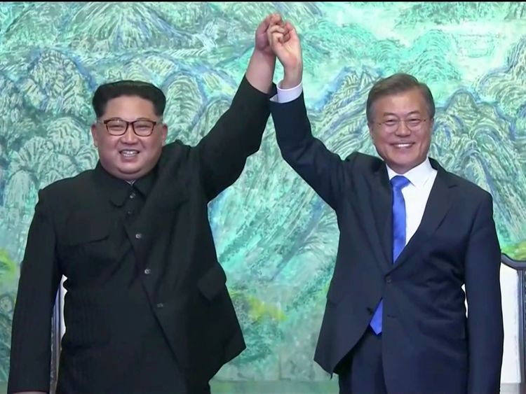 South Korean President Moon Jae-in and North Korean leader Kim Jong Un gesture after signing agreements