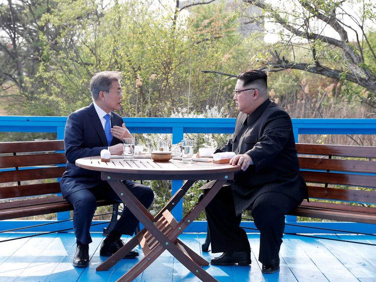 South Korean President Moon Jae-in and North Korean leader Kim Jong Un sit together at the truce village of Panmunjom 