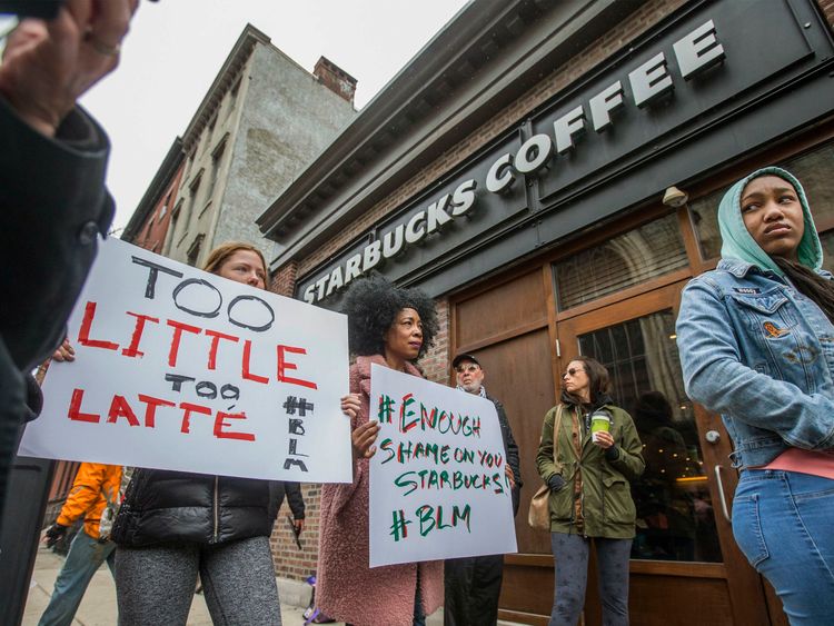 Protesters gather outside of a  Starbucks in Philadelphia where two black men were arrested