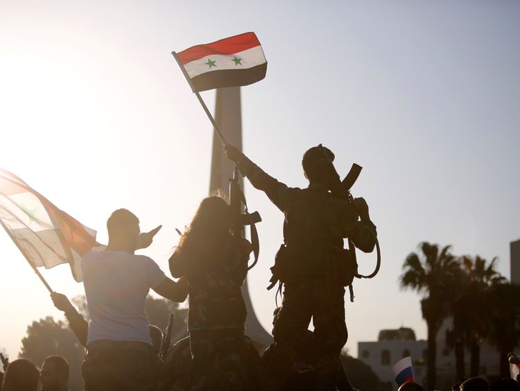 Syrians protest against US-led airstrikes on a street in Damascus