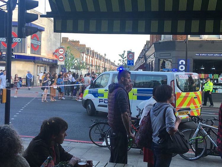 Police outside Tooting Bec Underground station in south London, where two men were stabbed after a fight at rush hour