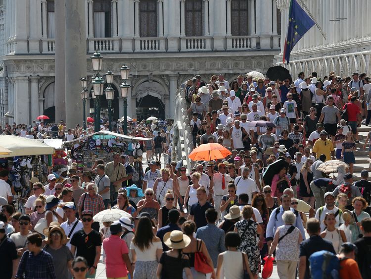 Tourists walk near St. Mark's Square in Venice, Italy, August 3, 2017