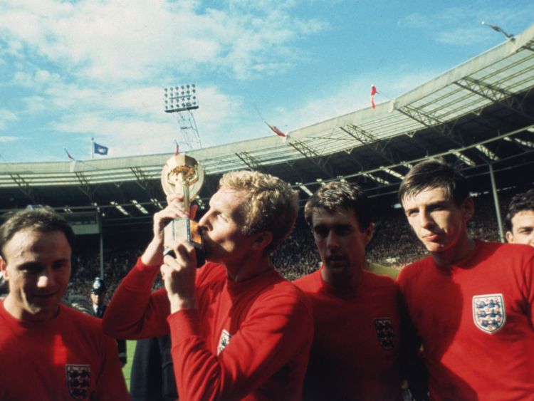 1966: England captain Bobby Moore kissing the Jules Rimet trophy as the team celebrate winning the 1966 World Cup final against Germany 