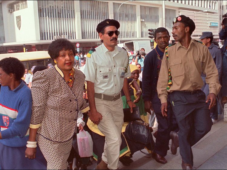 Winnie Mandela (L) arrives at the Rand Supreme court in Johannesburg, 07 March 1991, for her trial where she is facing charges of kidnapping and assault. A state witness testified that the wife of anti-apartheid leader Nelson Mandela had personnaly beat and whipped him and three other black youths at her home in December 1988. (Photo credit should read TREVOR SAMSON/AFP/Getty Images)