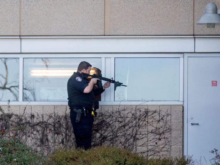 A police officer sweeps a building at YouTube&#39;s corporate headquarters