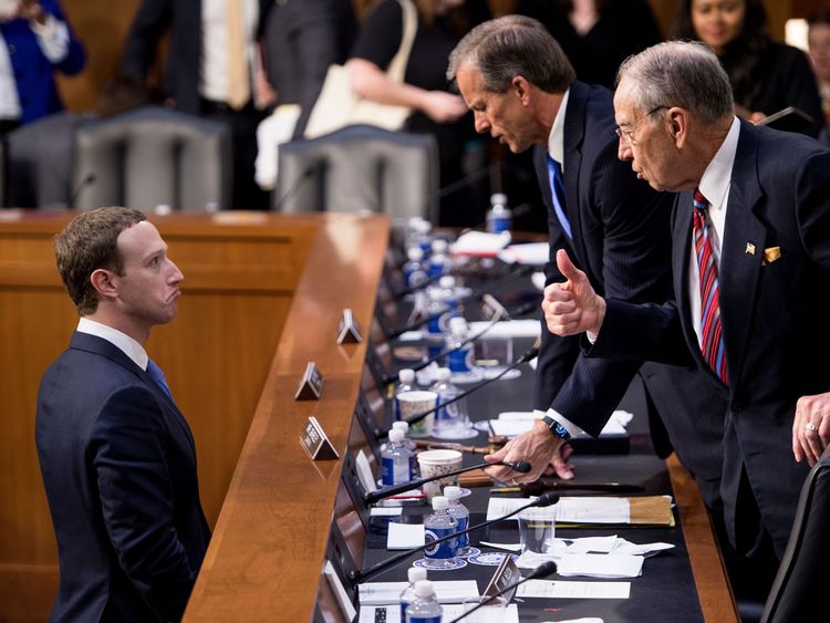 Mark Zuckerberg (L) speaks with Senator John Thune (C), R-SD, and Senator Chuck Grassley (R)