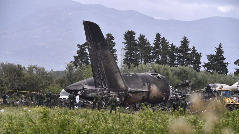 TOPSHOT - Rescuers are seen around the wreckage of an Algerian army plane which crashed near the Boufarik airbase from where the plane had taken off on April 11, 2018. The Algerian military plane crashed and caught fire killing 257 people, mostly army personnel and members of their families, officials said. / AFP PHOTO / Ryad KRAMDI (Photo credit should read RYAD KRAMDI/AFP/Getty Images)