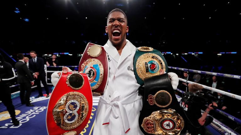 Anthony Joshua vs Joseph Parker - World Heavyweight Title Unification Fight - Principality Stadium, Cardiff, Britain - March 31, 2018 Anthony Joshua celebrates with the belts after winning the fight