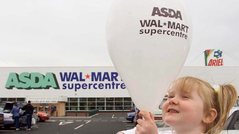 Chloe Edwards plays with a balloon outside the newly opened US giant retail store Asda Wal-Mart in Bristol, July 24, 2000. 
