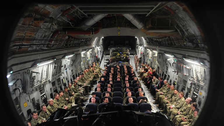 British troops and service personnel prepare to travel to Camp Bastion in Afghanistan on an RAF C17 aircraft from Oman