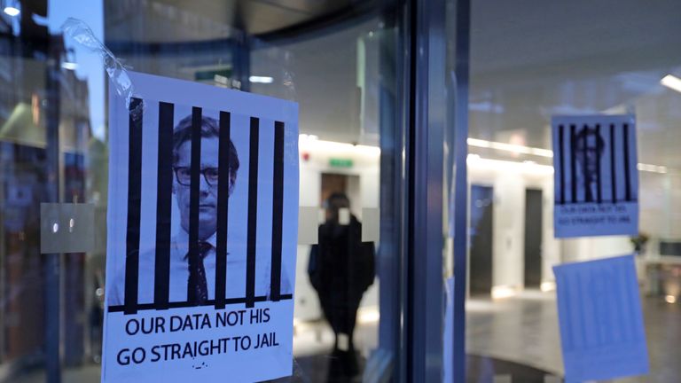 Posters depicting Cambridge Analytica&#39;s CEO Alexander Nix behind bars at the entrance of the company&#39;s London offices