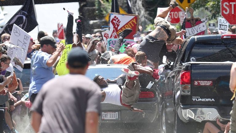 A vehicle plows into a group of protesters marching along 4th Street NE at the Downtown Mall in Charlottesville