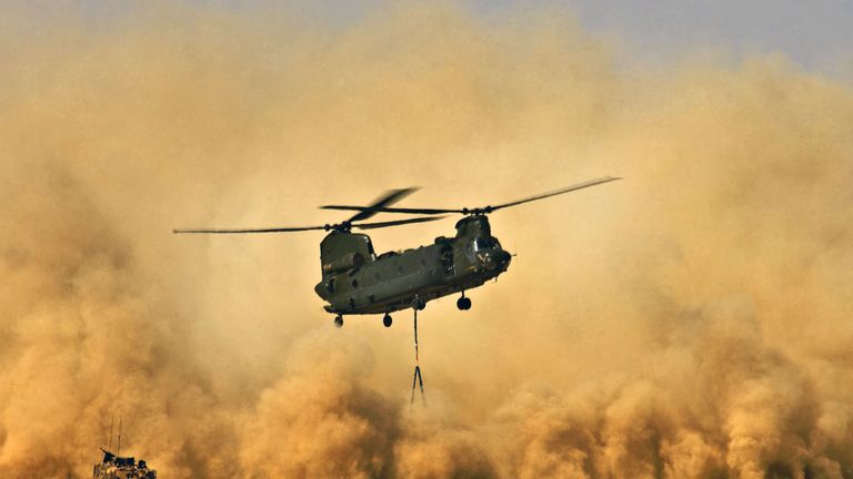 Undated handout photo issued by The Ministry of Defence of a Royal Air Force CH47 Chinook Helicopter creating a dust storm during the re-supply of the men of 42 Commando Royal Marines at Patrol Base Delhi