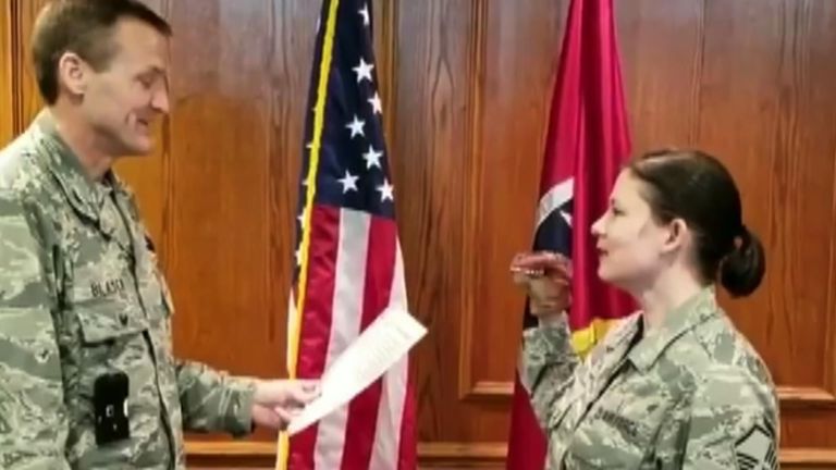 Master Sergeant Robin Brown uses a dinosaur puppet during her enlistment ceremony