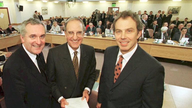 Former prime minister Tony Blair (R), US Senator George Mitchell (C) and Irish Prime Minister Bertie Ahern (L) smiling after signing the Good Friday agreement