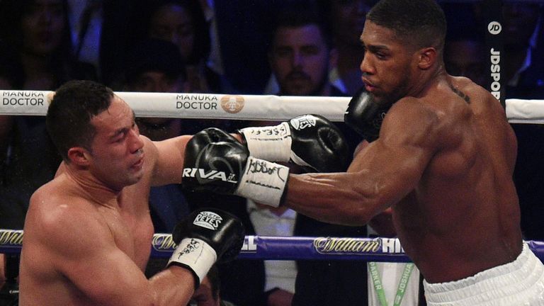 Anthony Joshua (R) aims a jab at Joseph Parker (L) in the final round of their heavyweight unification fight in Cardiff