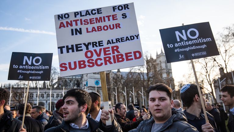 MARCH 26: Protesters hold placards as they demonstrate in Parliament Square against anti-Semitism in the Labour Party on March 26, 2018 in London, England.