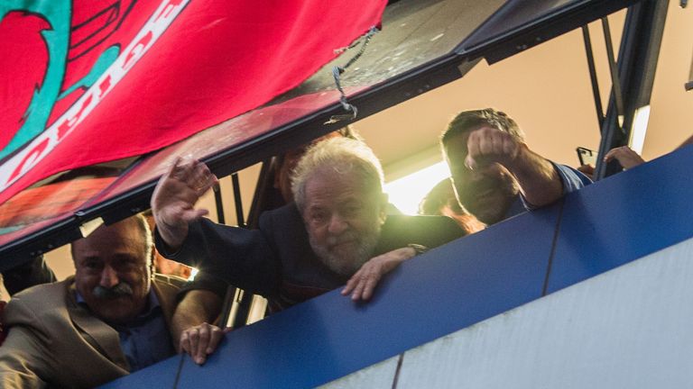 Lula da Silva waves to his supporters at the window of the Metalworkers&#39; Union