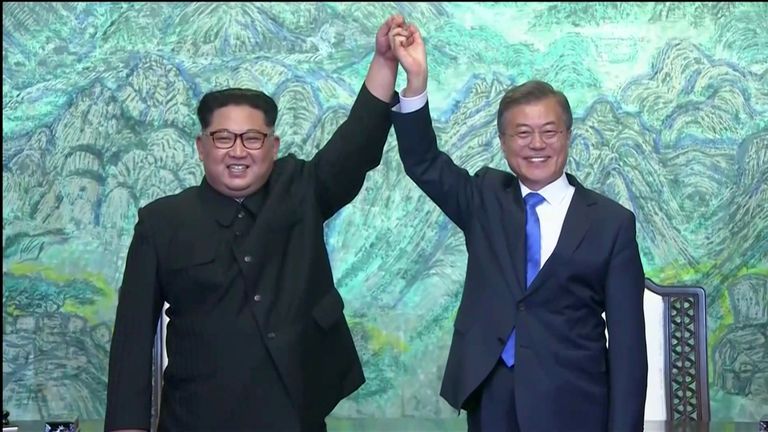 South Korean President Moon Jae-in and North Korean leader Kim Jong Un gesture after signing agreements