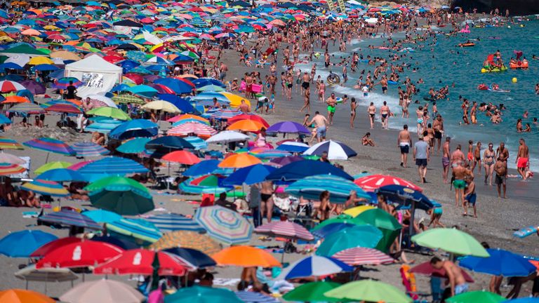 People sunbathe on the Burriana beach in Nerja, near Malaga, in Spain's Costa del Sol