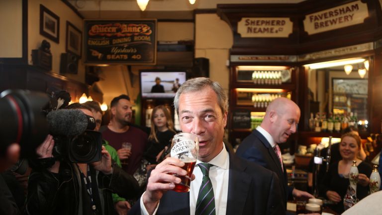 Ukip leader Nigel Farage has a pint in the Westminster Arms, London, as he celebrates his party&#39;s results in the polls for the European Parliament. 