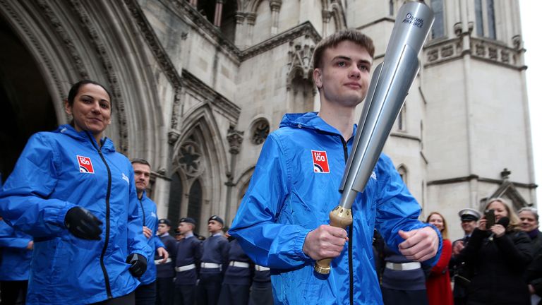 Adam Wood, who read out the Queen&#39;s message, with the RAF100 Baton