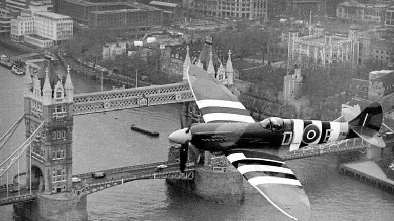 File photo dated 01/11/06 of a Spitfire in Normandy invasion markings flying over Tower Bridge in London, as the RAF celebrates its centenary on Sunday