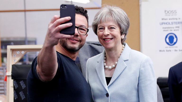 Theresa May poses for a selfie with upholsterer Derek Whitehouse during a campaign visit to Dudley