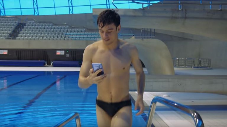 Daley is seen coming out of the pool with the phone. Pic: HTC