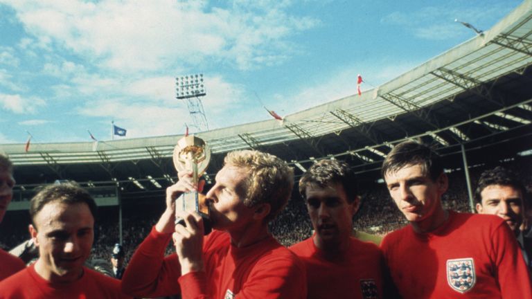 1966: England captain Bobby Moore kissing the Jules Rimet trophy as the team celebrate winning the 1966 World Cup final against Germany 